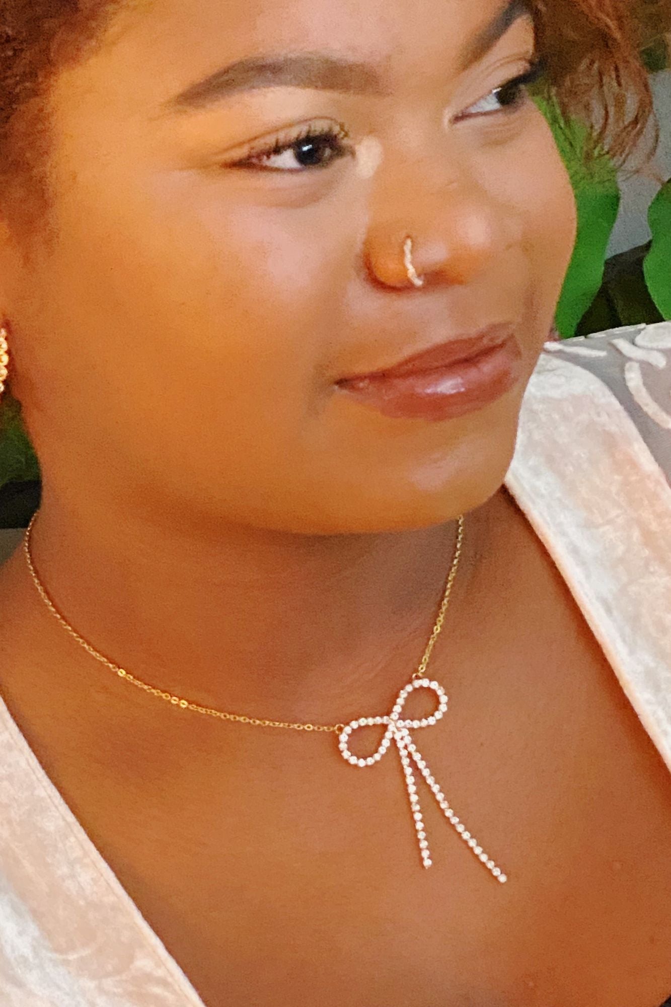 Elegant gold necklace featuring a sparkling crystal bow pendant, perfect for adding a touch of sophistication to any outfit.