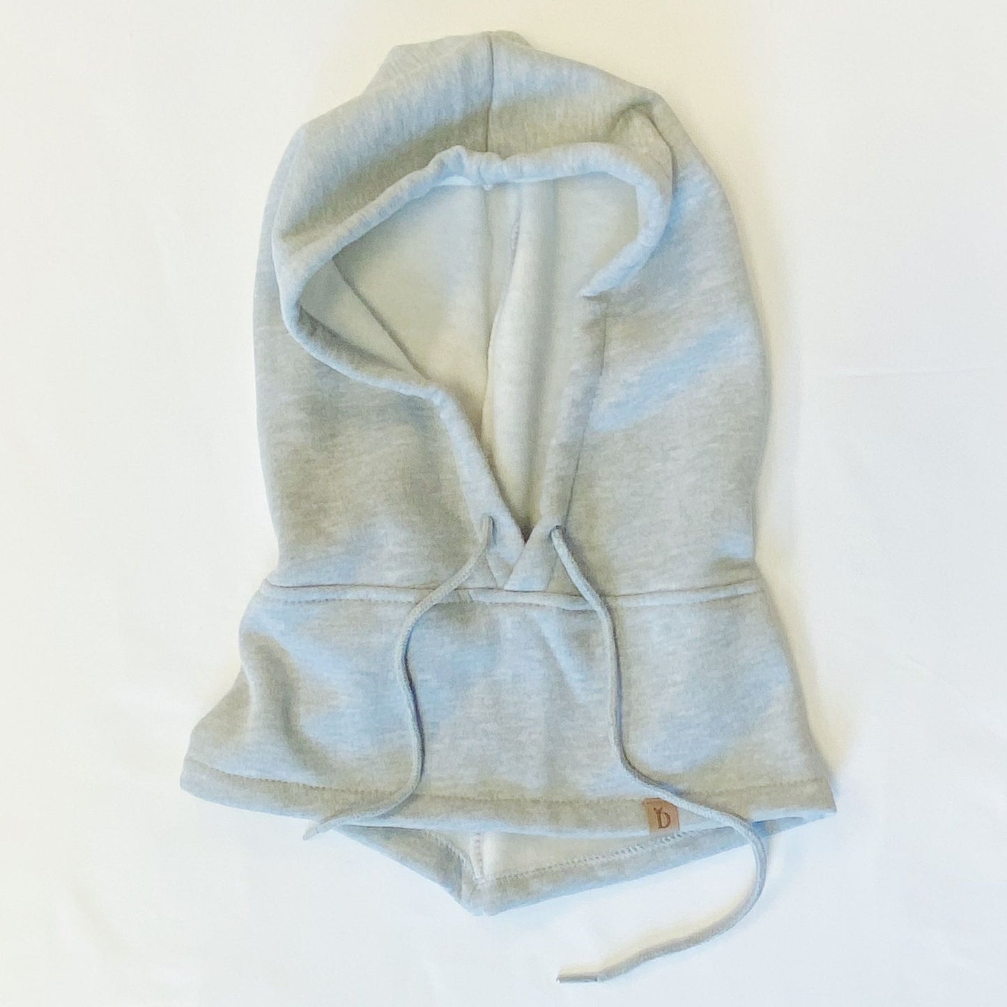 Light gray hooded sweatshirt with a cropped design and drawstring, featuring a small logo tag, laid flat on a white background.