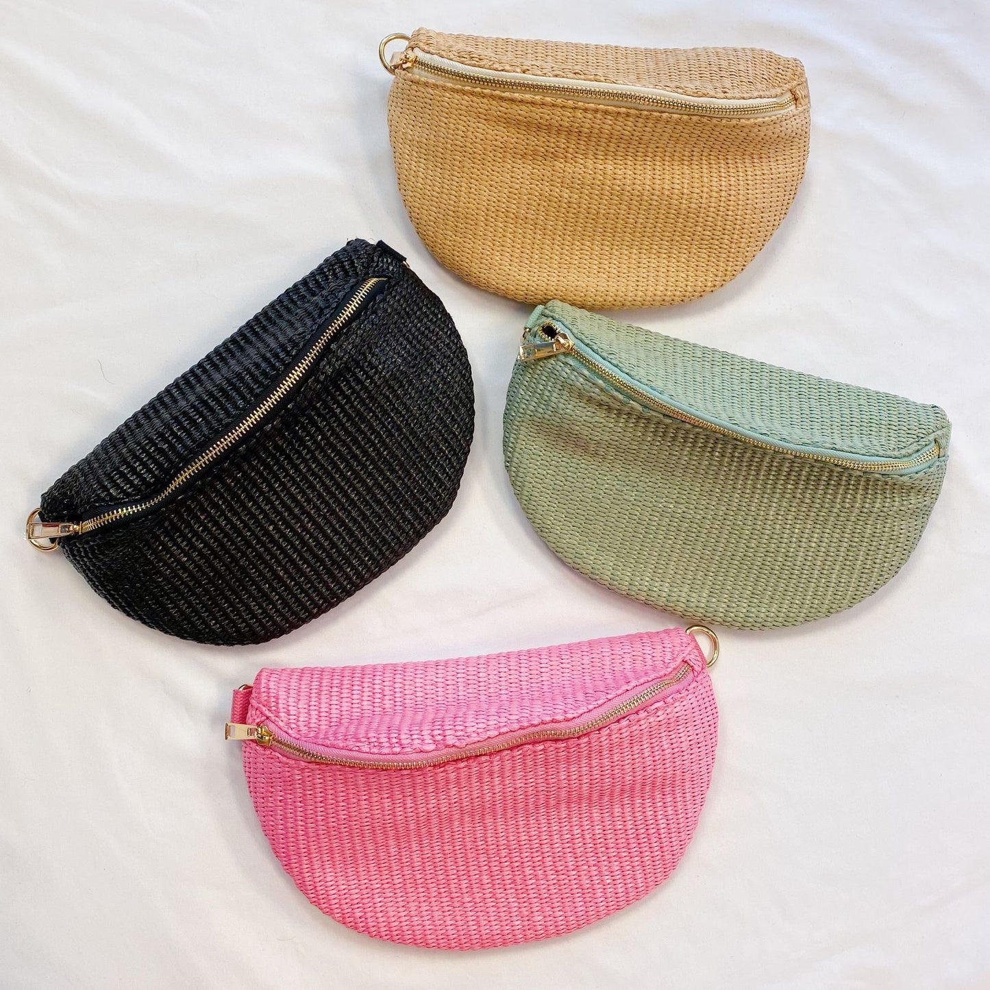 Set of four stylish woven clutch bags in neutral colors including beige, black, mint green, and bright pink, featuring gold zippers against a light background.