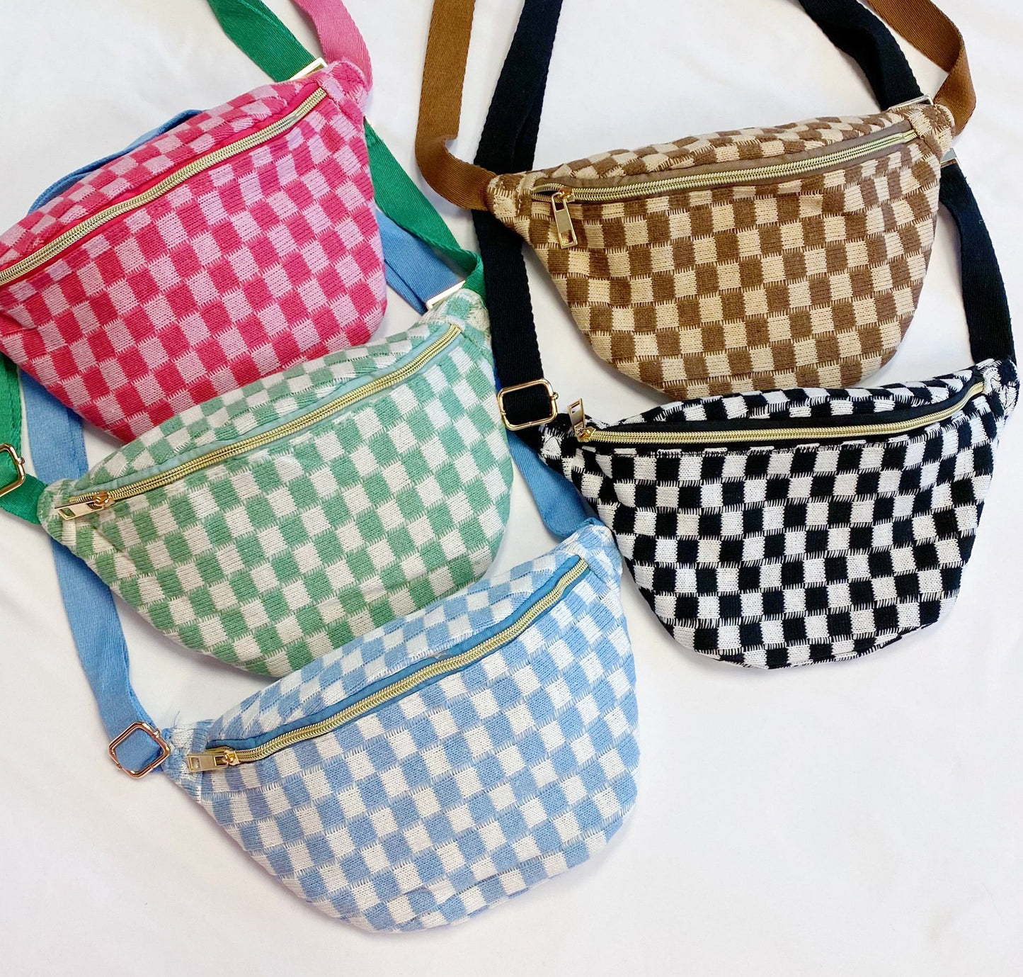 collection of stylish checkered fanny packs in vibrant colors including pink, green, blue, brown, and black, featuring zippers and adjustable straps, displayed on a light background
