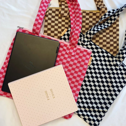 Colorful checkered tote bags in pink, brown, and black with a laptop and a planner, showcasing stylish organization for school or work essentials.