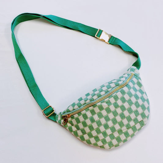 Green and white gingham fanny pack with adjustable strap and gold zipper closure, perfect for casual outings and hands-free convenience.