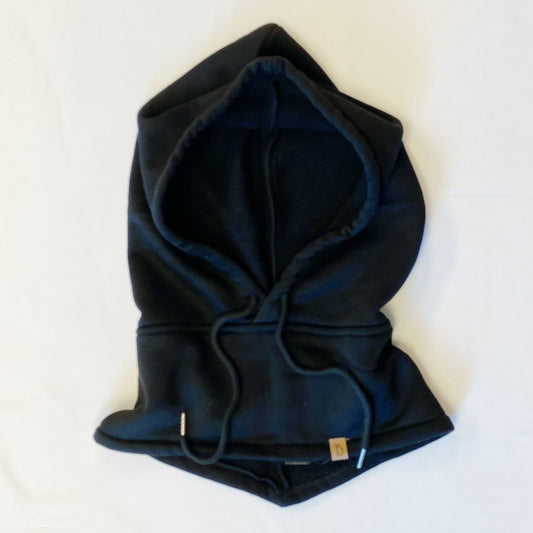 Black fleece hoodie with drawstrings, laid flat on a white background, showcasing its cozy and stylish design.