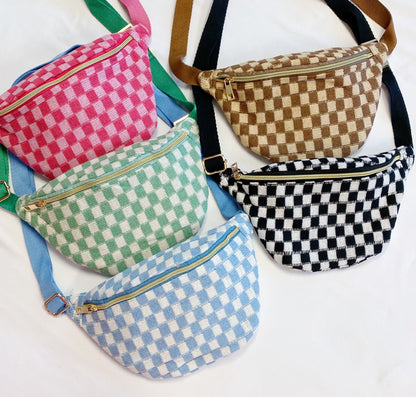 collection of stylish checkered fanny packs in vibrant colors including pink, green, blue, brown, and black, featuring zippers and adjustable straps, displayed on a light background